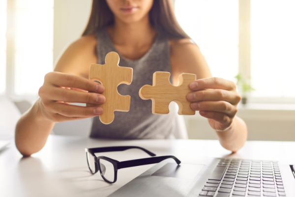 Woman placing puzzle pieces